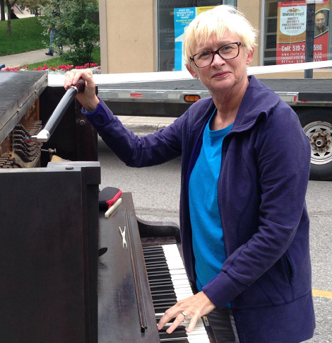 Louise in front of a piano